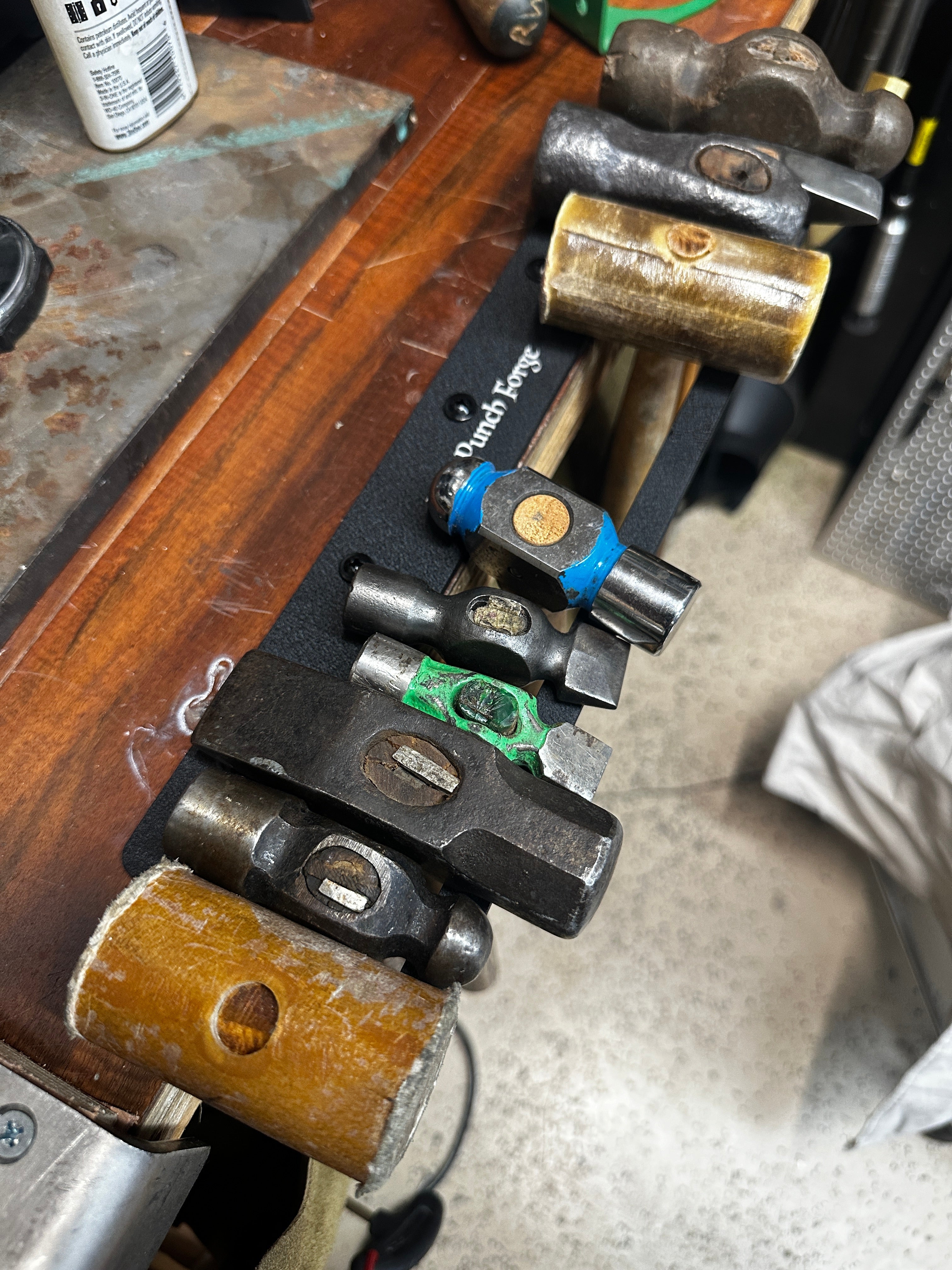 Set of hammers on a stand with a jewelry workshop background