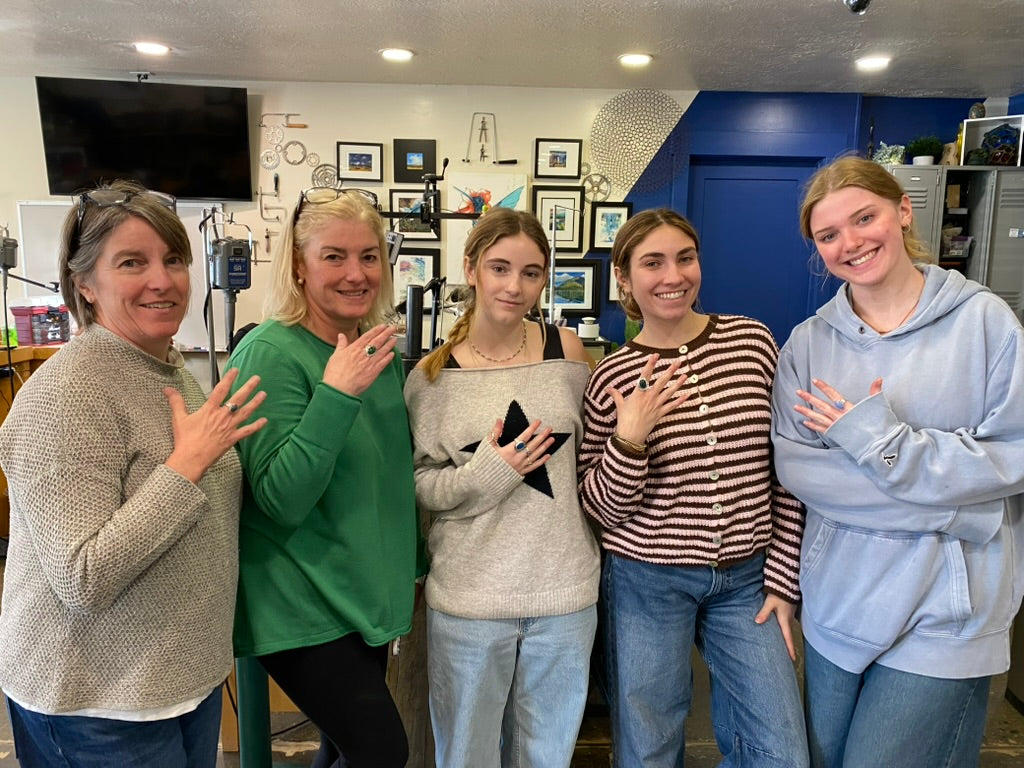 Group photo of students showing off their bezel soldered rings.
